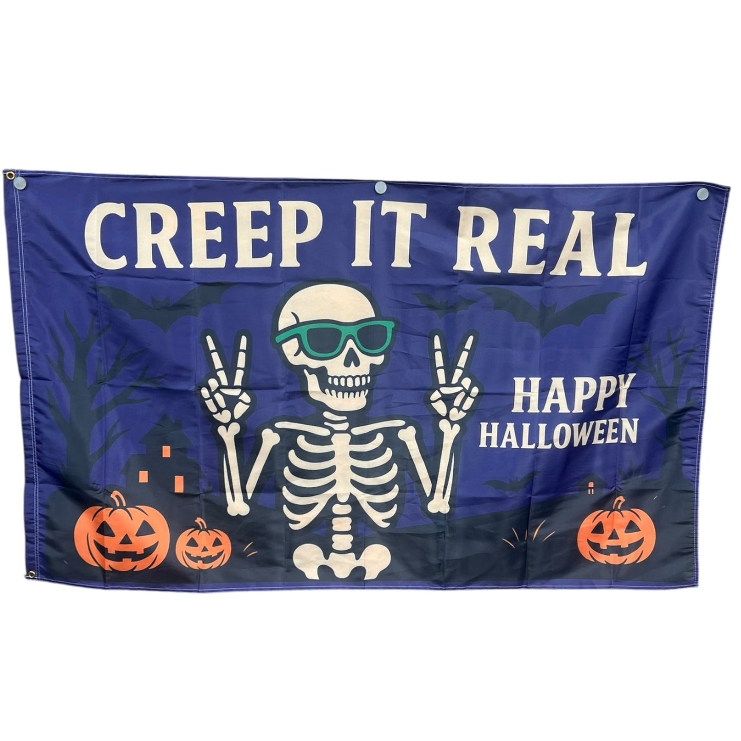 Halloween-themed flag with skeleton, pumpkins, and text 'Creep It Real Happy Halloween' on a blue background.