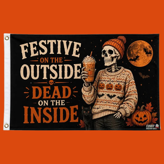 A rectangular Halloween-themed flag or banner with a white hoist sleeve and metal grommets on the left. The printed design shows a skeleton in a patterned sweater holding an iced coffee, with pumpkins, bats, a full moon, and the text 'FESTIVE ON THE OUTSIDE / DEAD ON THE INSIDE' on a black background.